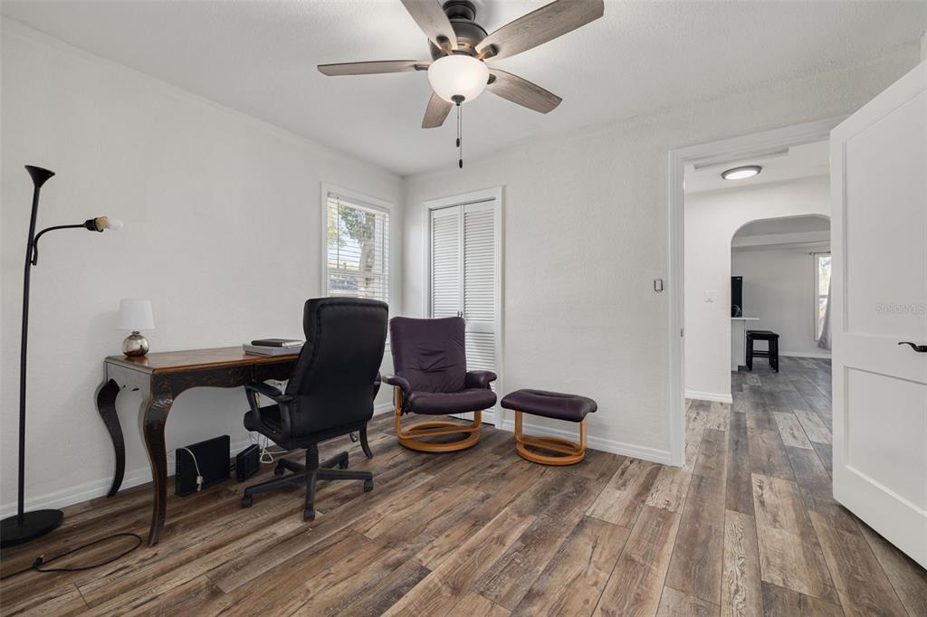 200 Broadway Dunedin, FL 34698 - Photo 16 of 59 a workspace with wooden floor and a rug