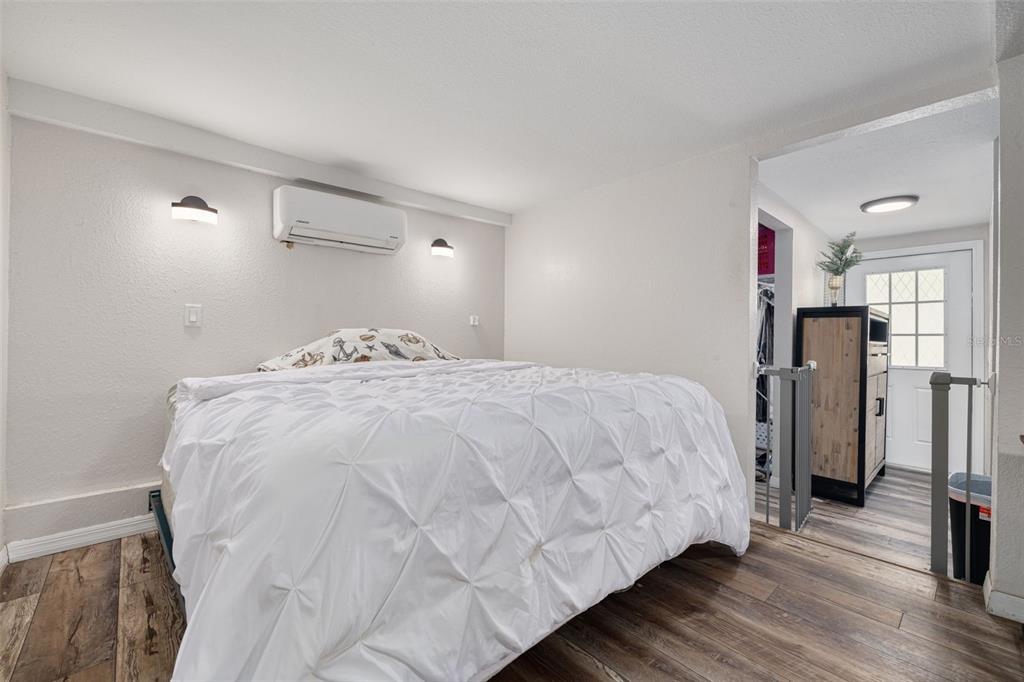 200 Broadway Dunedin, FL 34698 - Photo 19 of 59 a bedroom with a bed and a refrigerator