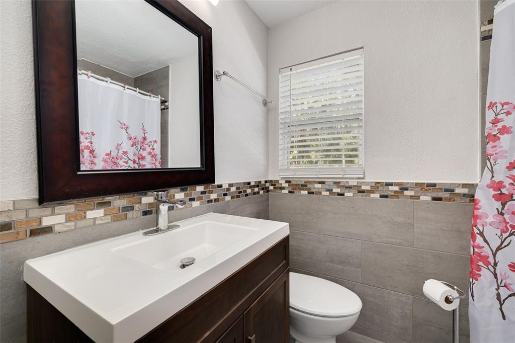 200 Broadway Dunedin, FL 34698 - Photo 24 of 59 a bathroom with a sink and a mirror