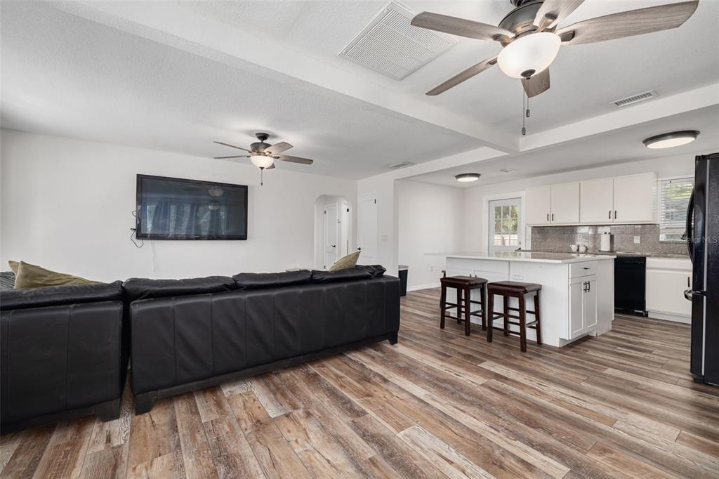 200 Broadway Dunedin, FL 34698 - Photo 8 of 59 a living room with stainless steel appliances kitchen island granite countertop furniture and a large window