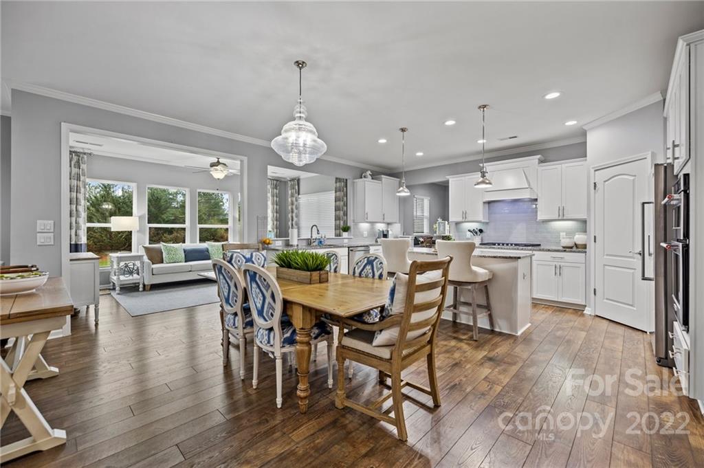 270 Hampton Trail Drive Fort Mill, SC 29708 - Photo 12 of 42 a view of a dining room and livingroom with furniture wooden floor a rug and a chandelier