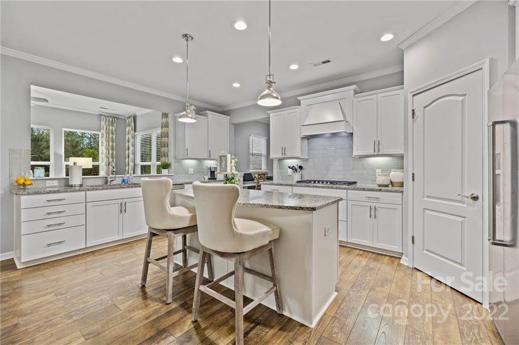 270 Hampton Trail Drive Fort Mill, SC 29708 - Photo 18 of 42 a kitchen with kitchen island granite countertop a sink cabinets and wooden floor