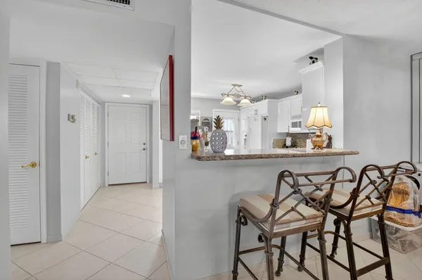 a kitchen with a table and chairs in it