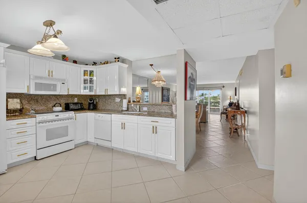 a kitchen with a stove top oven sink and cabinets
