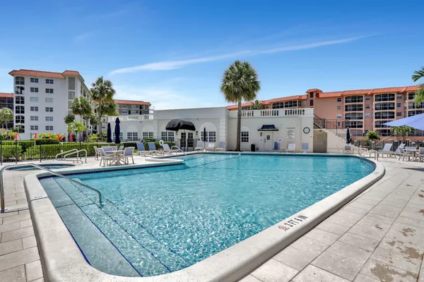 a view of a swimming pool with outdoor seating space