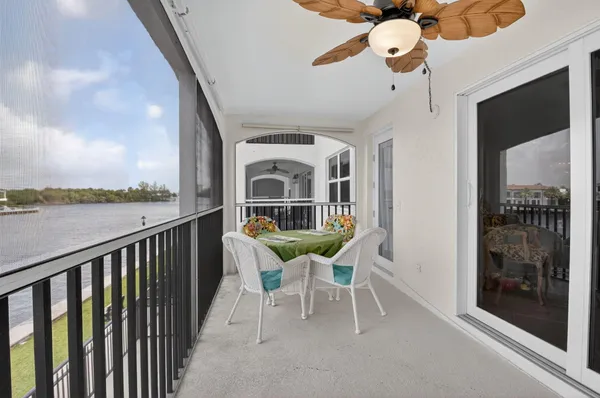 a balcony with table and chairs