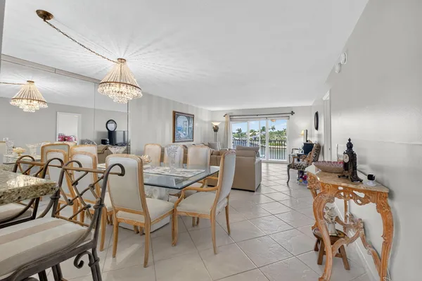 a view of a dining room with furniture and a chandelier