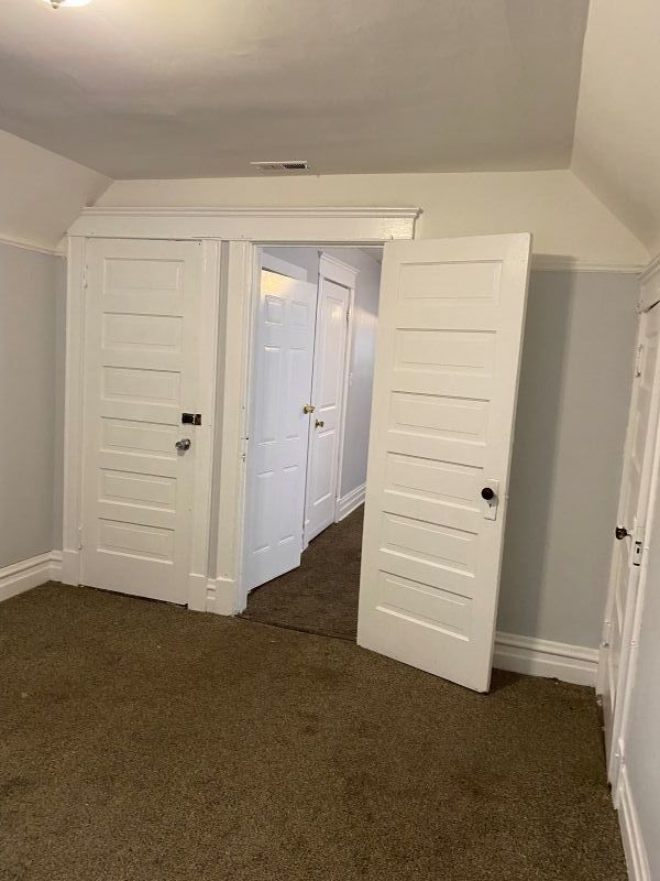 1340 East 76th Street, Unit 2 Chicago, IL 60619 - Photo 2 of 10 an empty room with a hallway and stairs