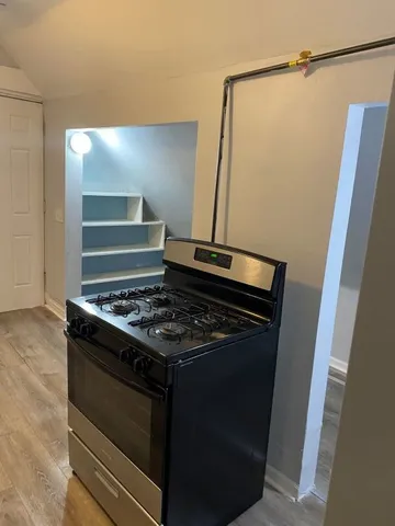 a stove top oven sitting inside of a kitchen