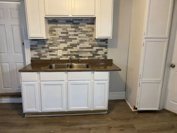 a sink sitting inside of a kitchen
