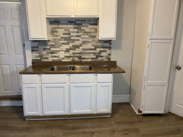 1340 East 76th Street, Unit 2 Chicago, IL 60619 - Photo 6 of 10 a sink sitting inside of a kitchen