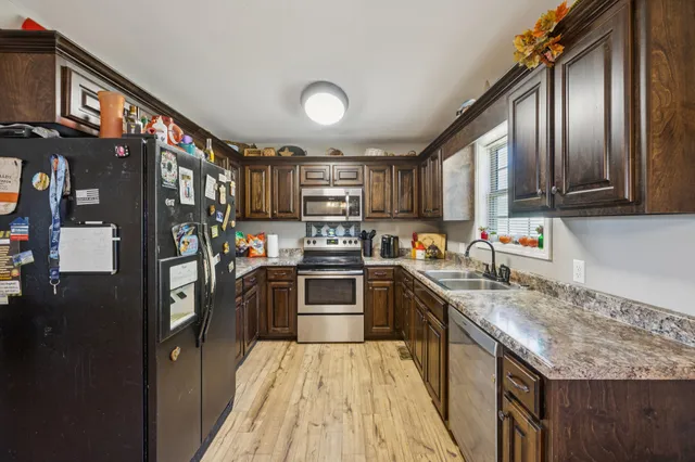 a kitchen with stainless steel appliances granite countertop lots of counter top space a sink and cabinets