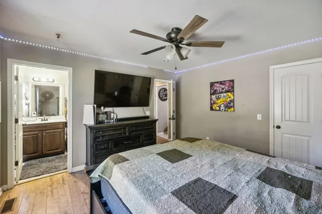 a bedroom with a bed and a flat screen tv