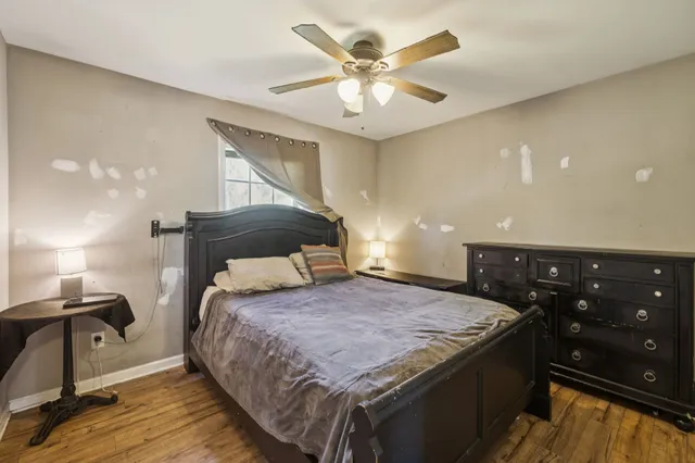 a bedroom with a bed and a chandelier