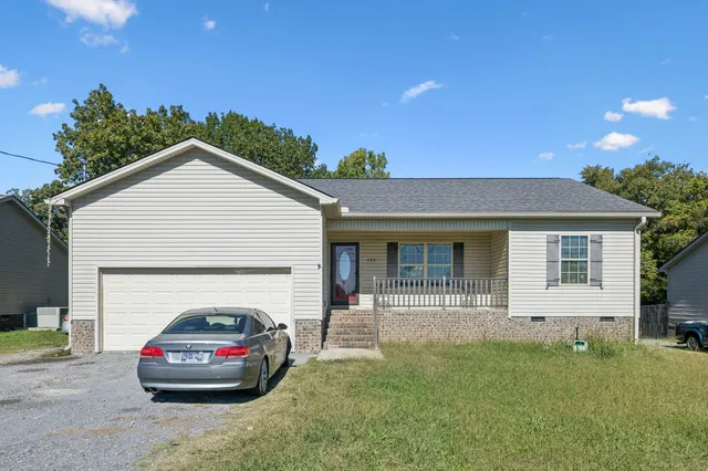 a car parked in front of white house