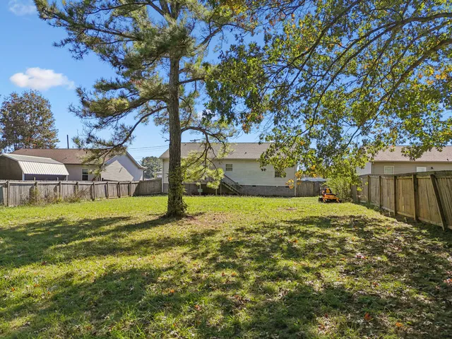a view of an house with backyard space and garden