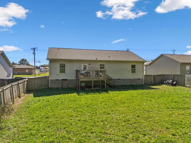 a view of a house with a backyard and a patio