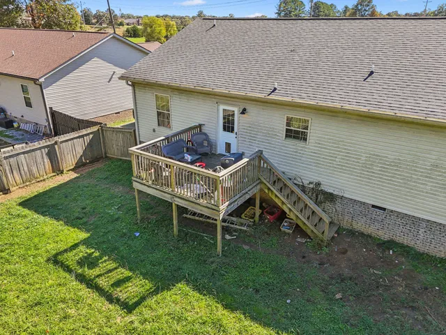 a view of a house with backyard and porch