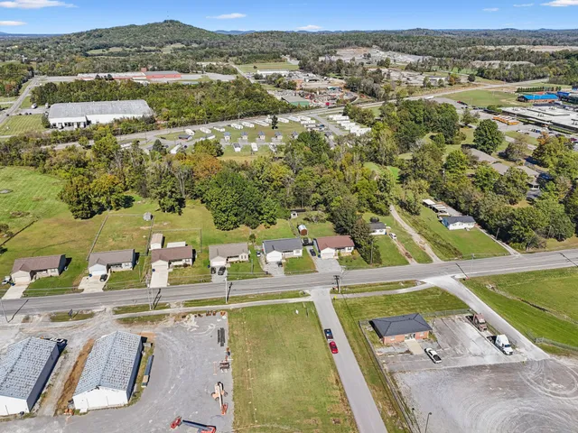 an aerial view of residential houses with outdoor space and river