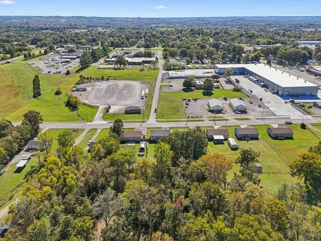 an aerial view of residential houses with outdoor space and swimming pool