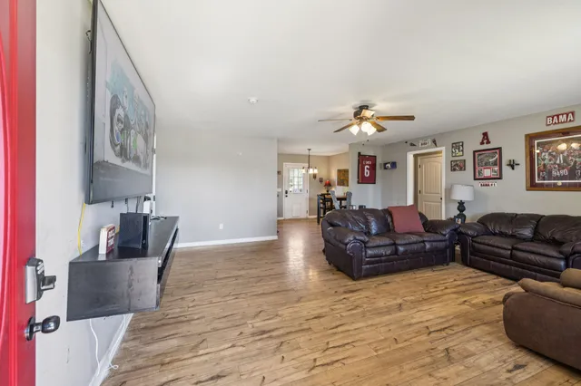 a living room with furniture and a chandelier