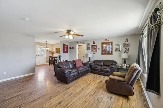 a living room with furniture and a chandelier