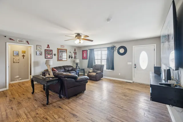 a living room with furniture and wooden floor