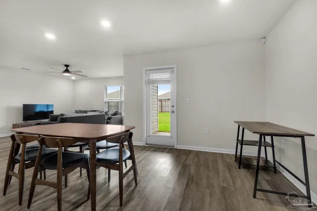 a dining room with a table chairs and a wooden floor