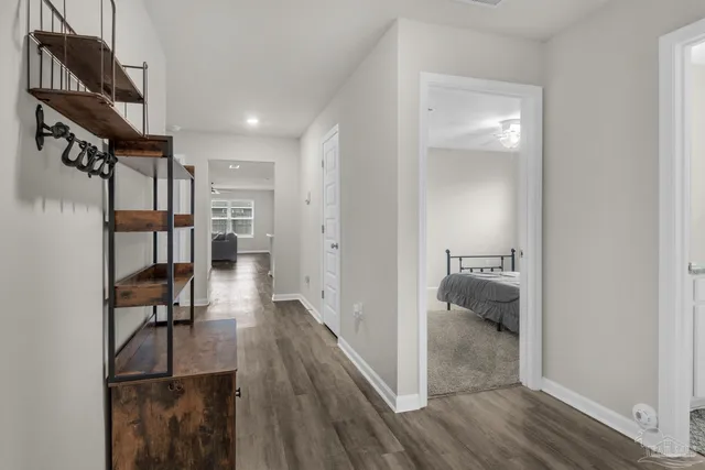 a view of a hallway with wooden floor fireplace and living room