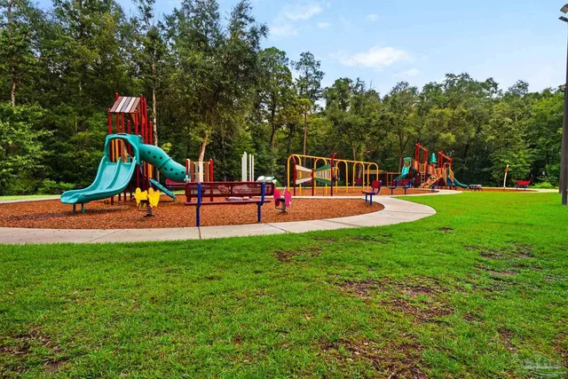 a view of park with swings and slides