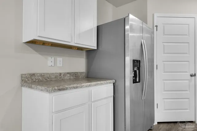 a kitchen with a refrigerator and cabinets