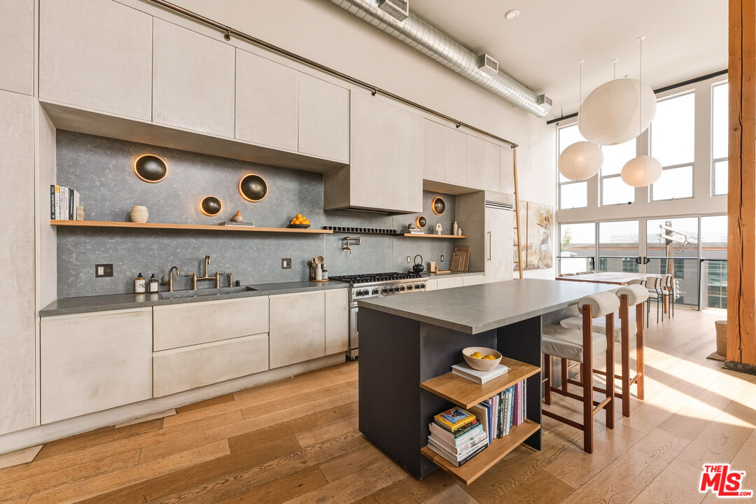 4215 Glencoe Avenue, Unit 405 Marina del Rey, CA 90292 - Photo 11 of 45 a kitchen with stainless steel appliances granite countertop a stove a sink and a refrigerator with wooden floors