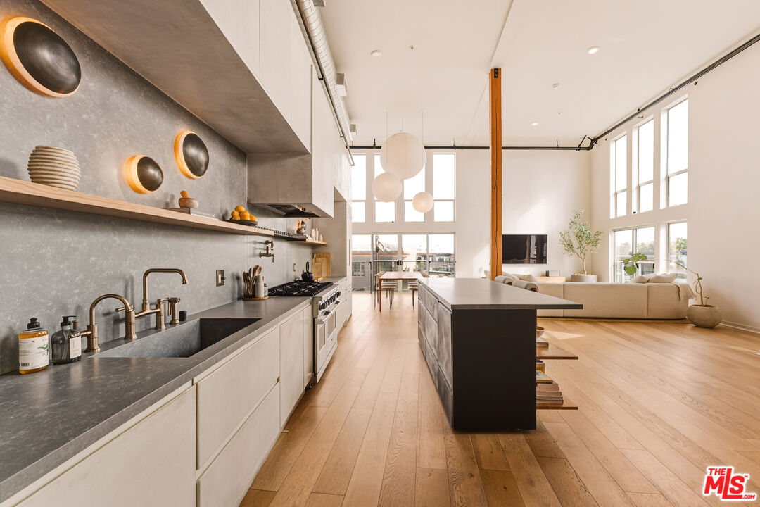 4215 Glencoe Avenue, Unit 405 Marina del Rey, CA 90292 - Photo 12 of 45 a view of a kitchen with kitchen island a large window a sink and counter top space