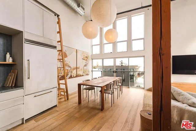 a kitchen with a table chairs a stove and a window
