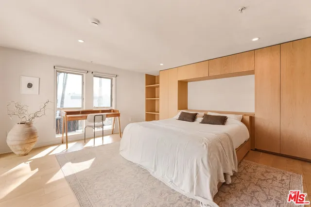 a bedroom with a large bed and a window