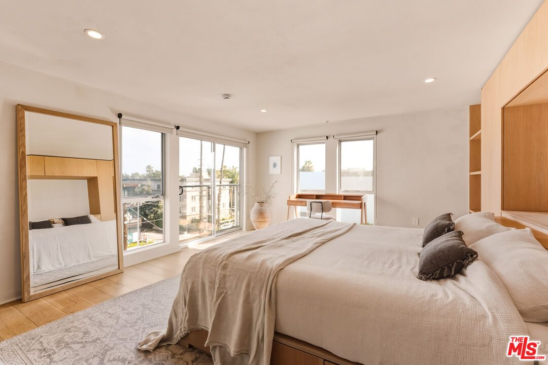 4215 Glencoe Avenue, Unit 405 Marina del Rey, CA 90292 - Photo 24 of 45 a bedroom with a large bed and a large window