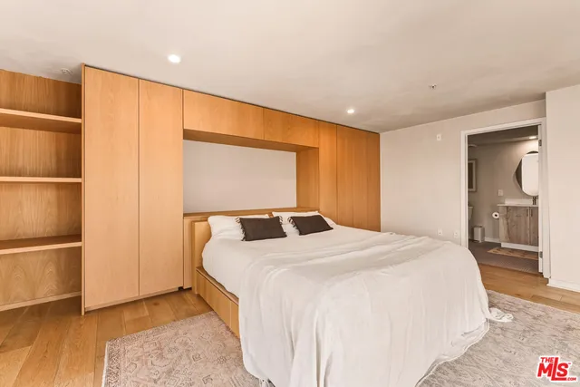 a bedroom with a bed and a cabinet