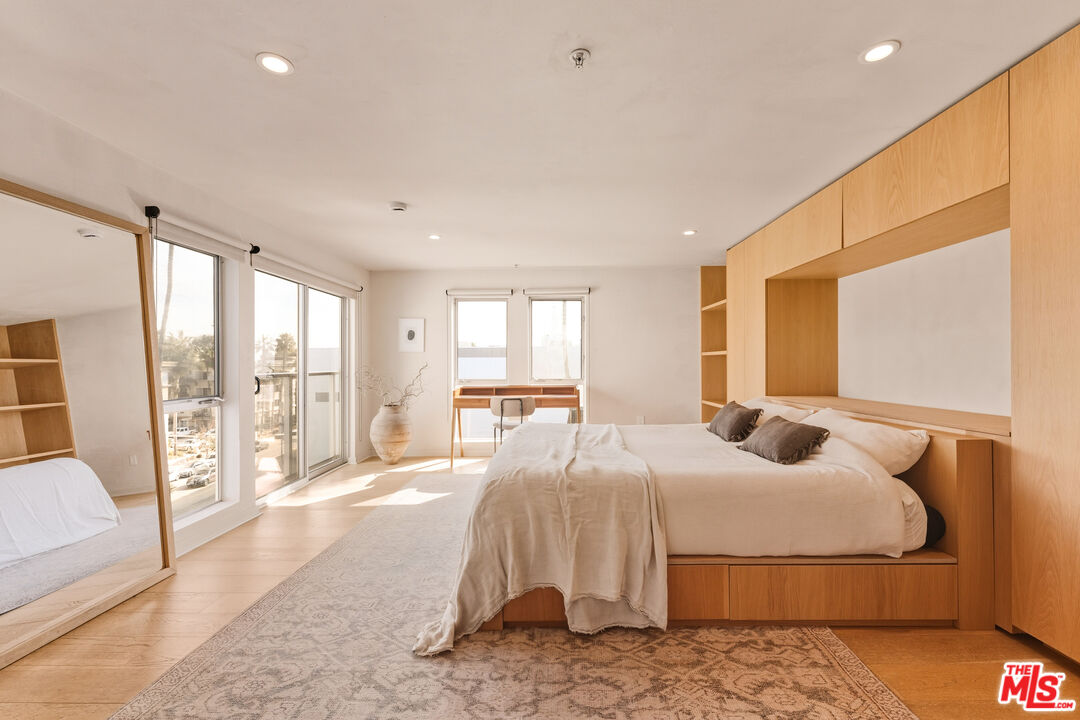 4215 Glencoe Avenue, Unit 405 Marina del Rey, CA 90292 - Photo 26 of 45 a bedroom with a large bed and a large window