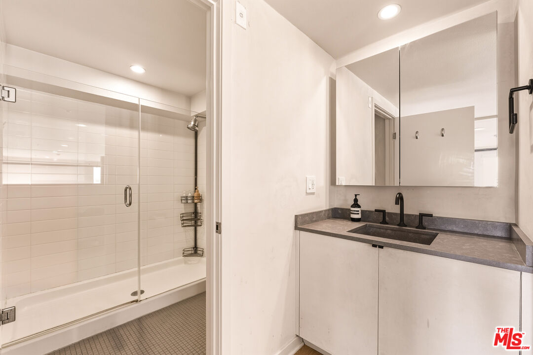 4215 Glencoe Avenue, Unit 405 Marina del Rey, CA 90292 - Photo 33 of 45 a bathroom with a double vanity sink mirror and shower