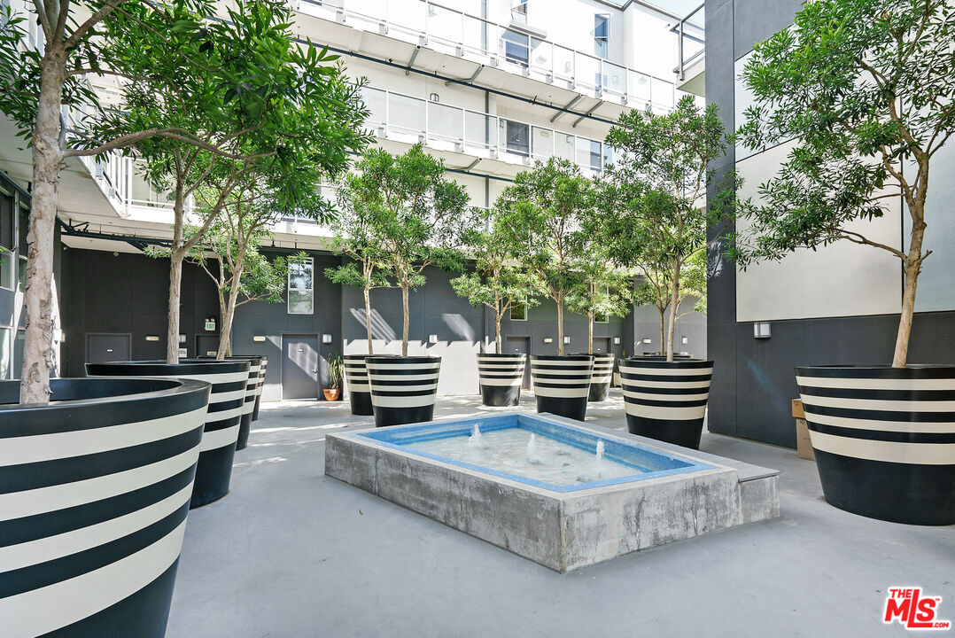 4215 Glencoe Avenue, Unit 405 Marina del Rey, CA 90292 - Photo 39 of 45 a backyard of a house with barbeque oven and outdoor seating