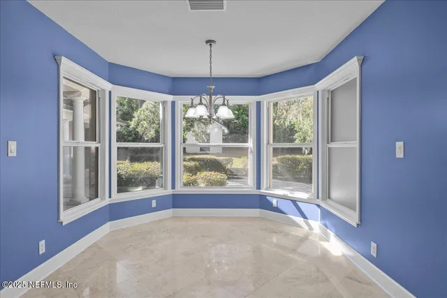 a view of a kitchen with a refrigerator and microwave