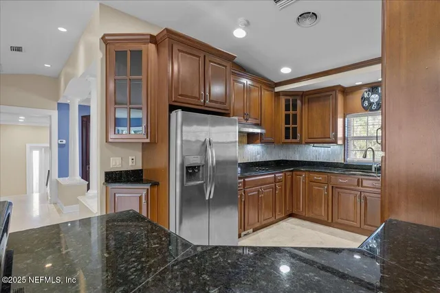 a kitchen with stainless steel appliances granite countertop a sink and cabinets