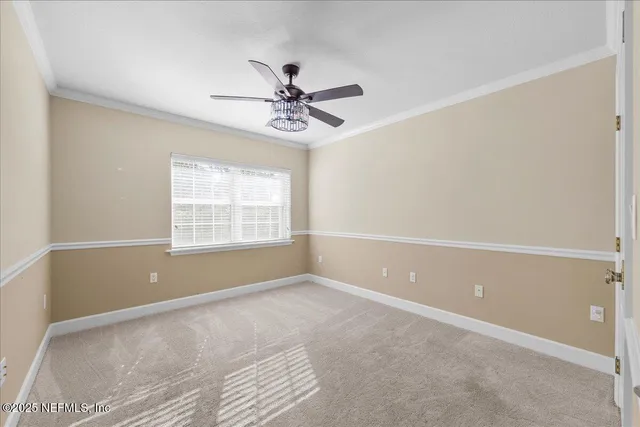 a view of a room with a ceiling fan