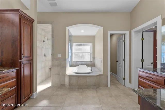 a bathroom with a granite countertop shower