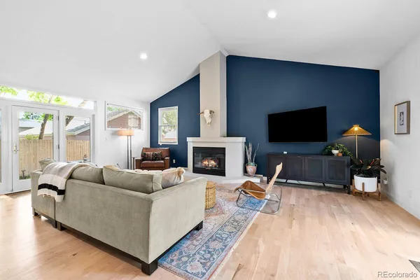 a living room with furniture and a fireplace