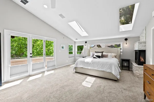 a bedroom with a large bed and a large window