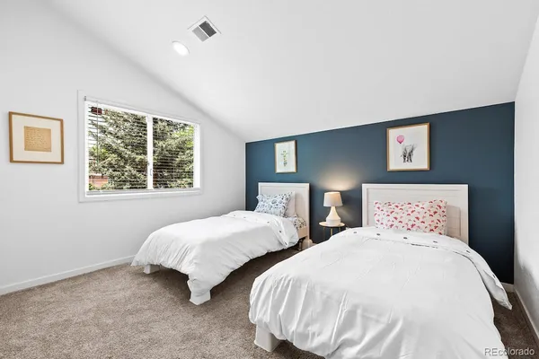 a bedroom with two beds and a window