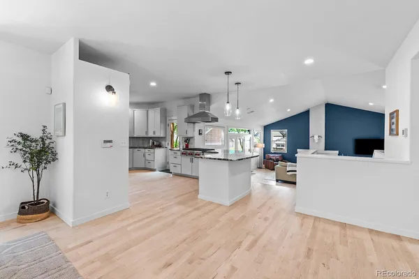 a view of kitchen with kitchen island stainless steel appliances refrigerator stove microwave and cabinets