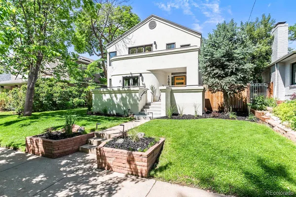 a view of a house with backyard sitting area and garden