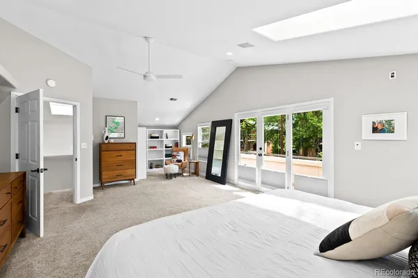 a spacious bedroom with a large bed and a large window